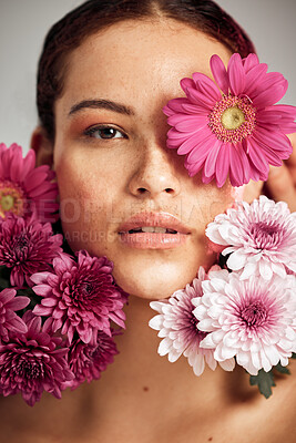 Buy stock photo Woman, flowers and studio portrait for beauty, wellness and skincare with spring aesthetic by background. Model, girl and carnation plant with cosmetic health, natural skin glow and symbol for growth