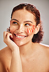 Woman face, makeup and flower for natural beauty skin glow, cosmetics and dermatology. Spa facial, health and wellness of happy aesthetic model person thinking floral product idea in studio
