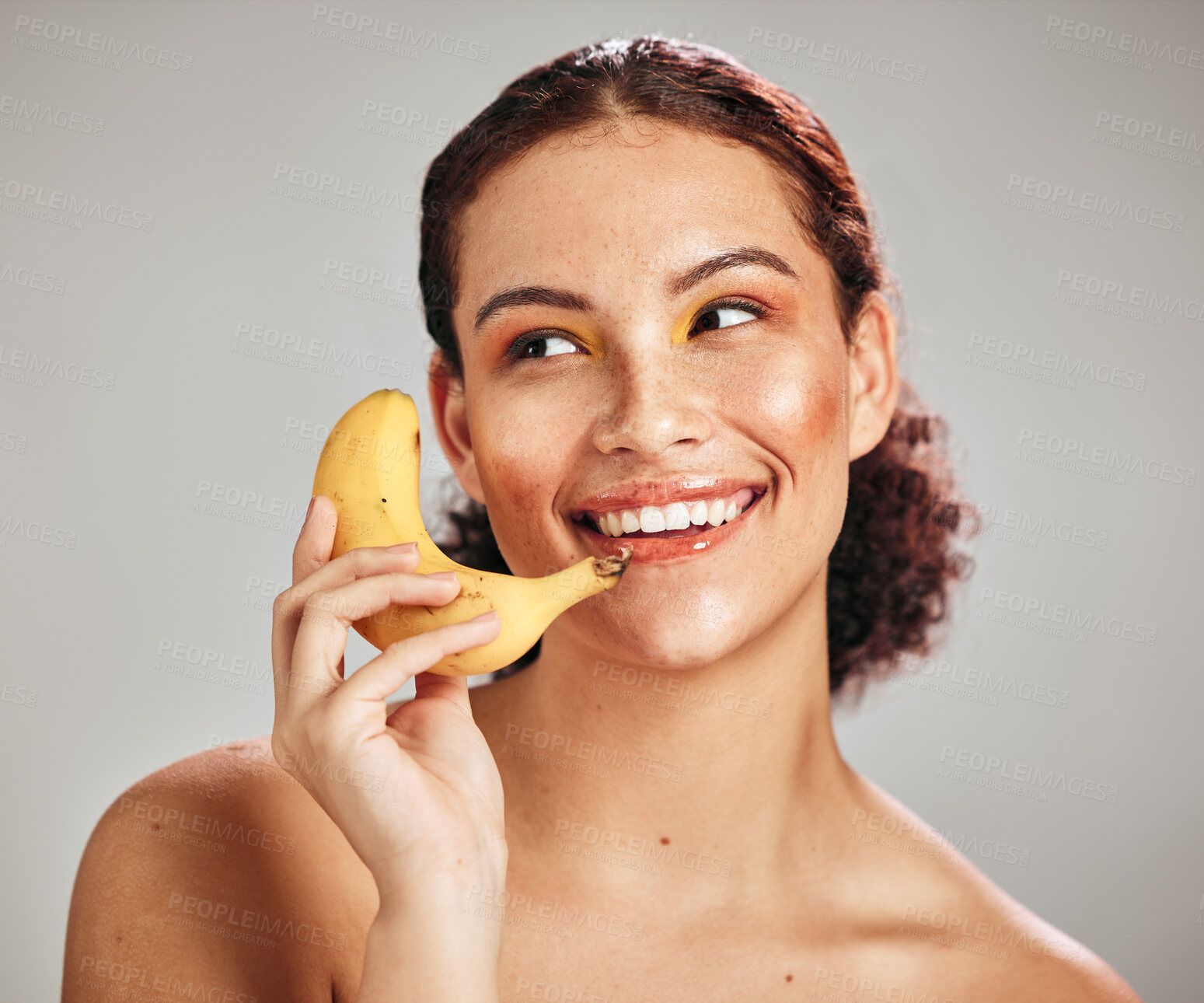 Buy stock photo Beauty makeup, face and woman with banana phone for facial skincare glow, fruit detox or natural dermatology. Wellness health product, nutritionist food and happy model isolated on studio background