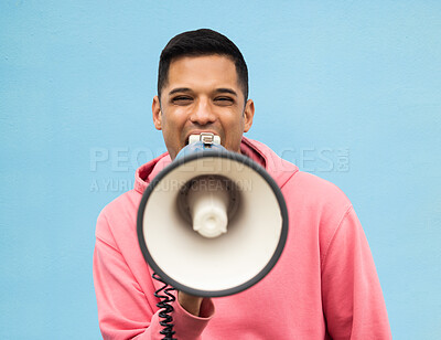 Buy stock photo Portrait, protest and megaphone with a man in studio on a blue background for an announcement or speech. Freedom, human rights and loudspeaker with a male at a rally for equality or revolution