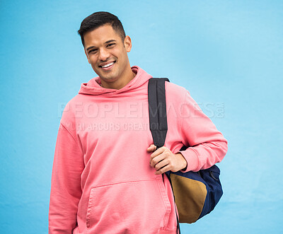 Buy stock photo University, student and portrait of man with backpack in studio, happy and smile on blue background. Face, handsome and college student excited about education, vision and career goal while isolated