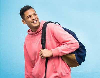 Buy stock photo Man, backpack and university student happy in studio, laughing and smile on blue background. Young, handsome and college student excited for education, vision and career goal while standing isolated