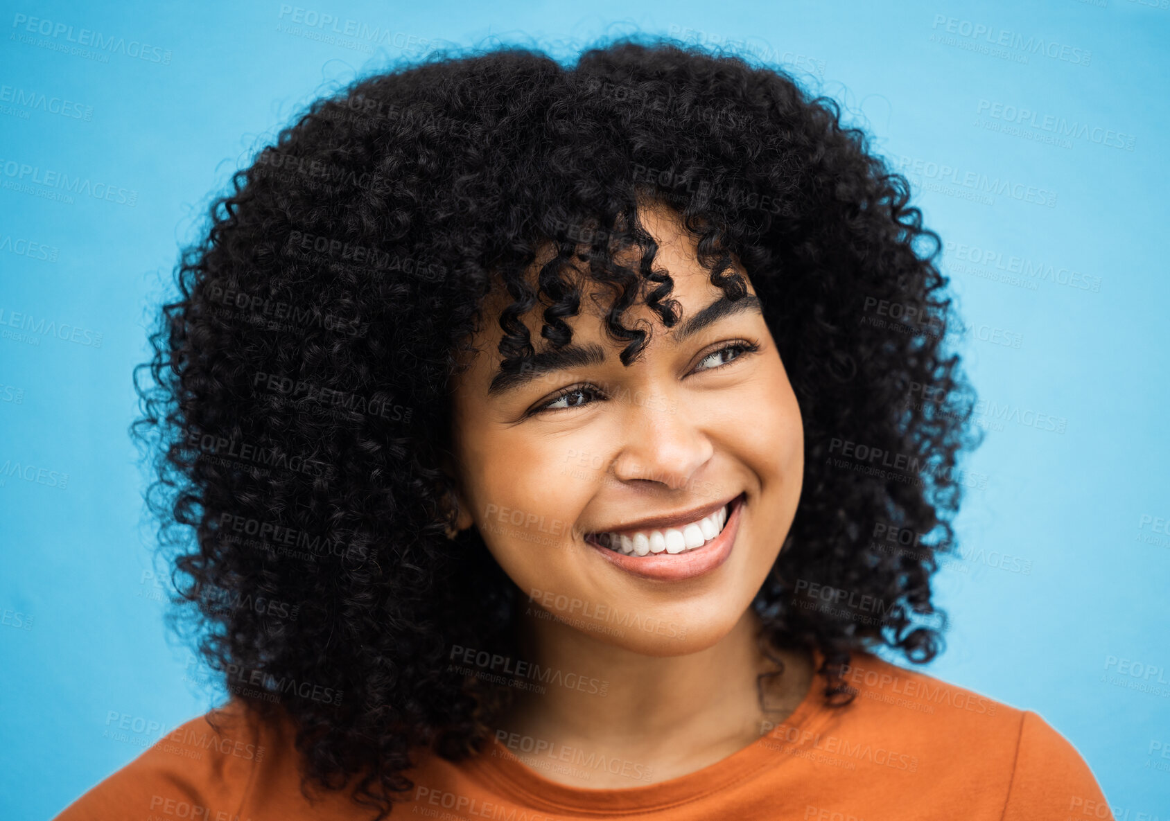 Buy stock photo Happy, black woman or afro hairstyle on isolated blue background with keratin treatment, self love or healthcare wellness. Headshot, smile or beauty model with curly brunette trend on urban city wall