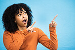 Black woman, surprise and pointing hands in studio for news announcement, gossip notification and blue background. African gen z girl, young female model and fashion for wow, hand sign and happiness