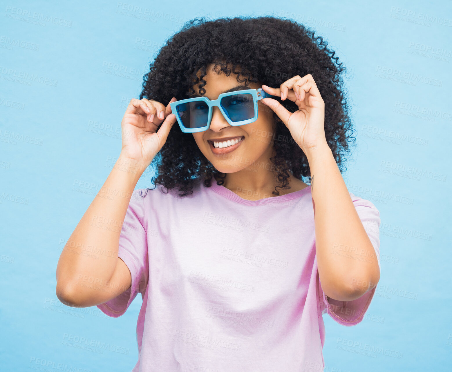 Buy stock photo Black woman, sunglasses and smile on a blue background with happy positive attitude and casual summer style. Portrait of African American female, person or lady model smiling in happiness for fashion