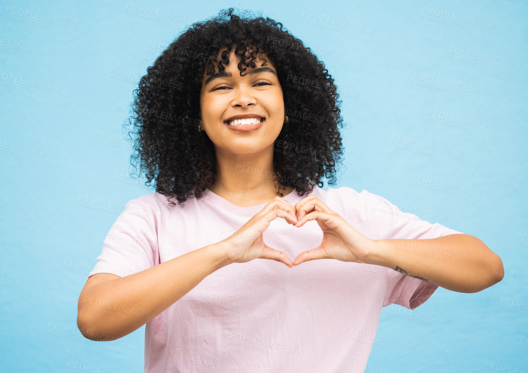 Buy stock photo Heart hand sign, black woman and smile portrait of a young person showing love gesture. African female, happiness and excited space with hands making emoji shape with blue studio background isolated