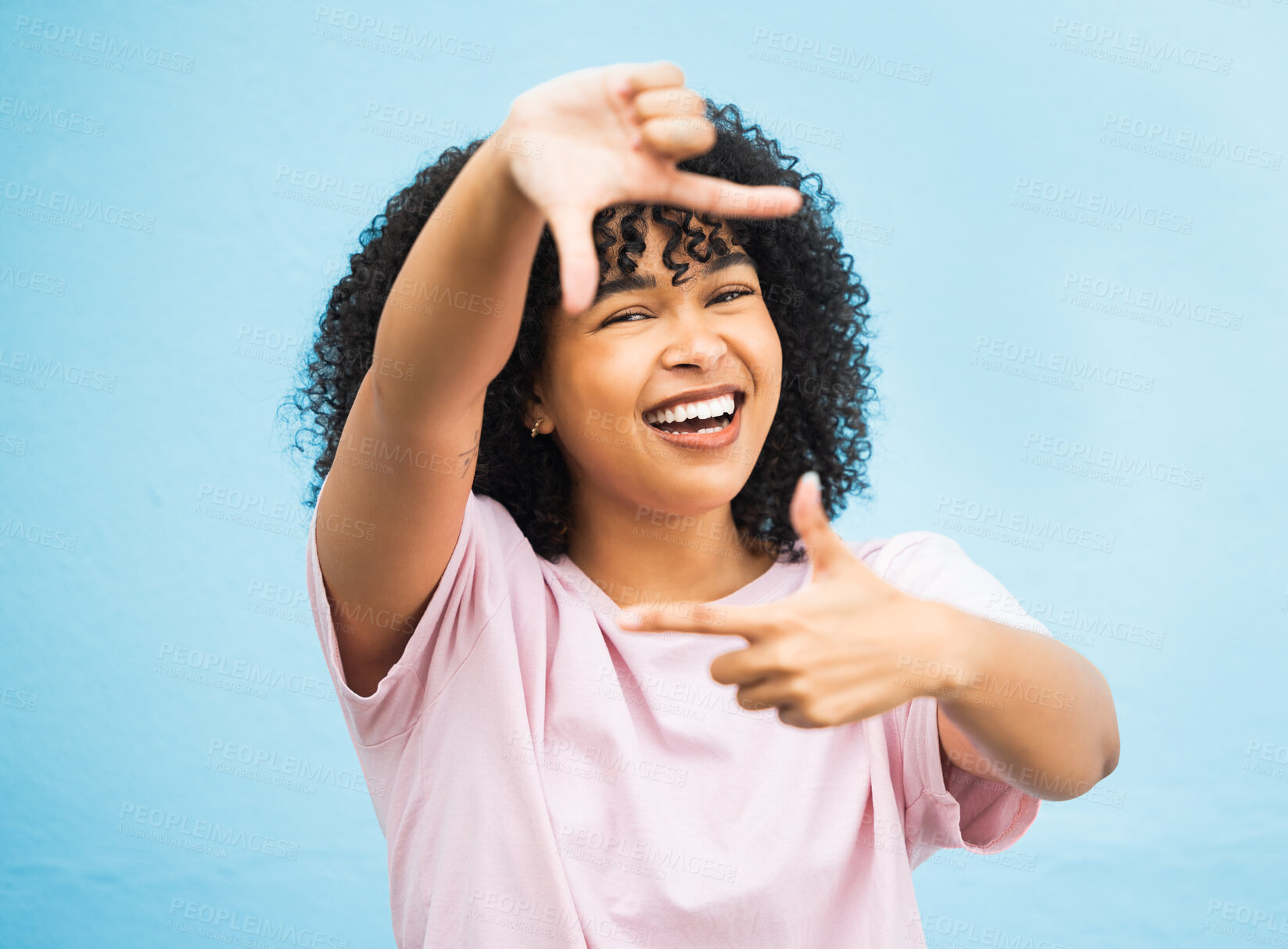 Buy stock photo Black woman, hands and smile for frame, picture perfect or photo against a blue studio background. Portrait of African American female, person or lady model smiling showing finger sign in photography