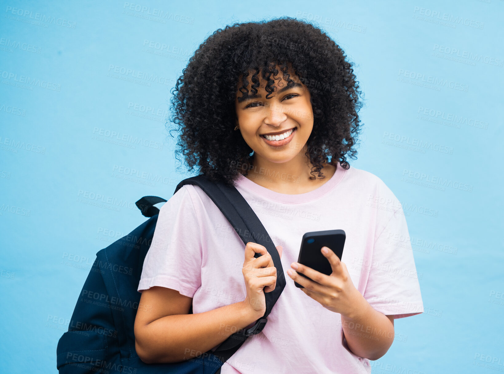 Buy stock photo Portrait, student and black woman with bag, phone and tech on blue background. Happy girl, backpack and young person with mobile on social media, educational app or reading online internet connection