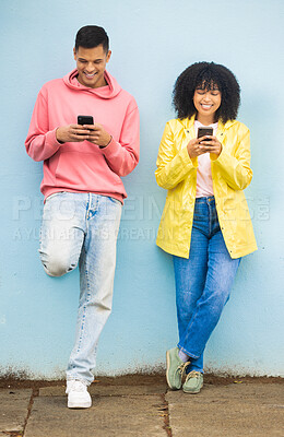 Buy stock photo Happy friends, bonding or phone typing on isolated blue background on social media, couple dating app or city networking. Smile, man or afro woman on mobile technology or community networking website