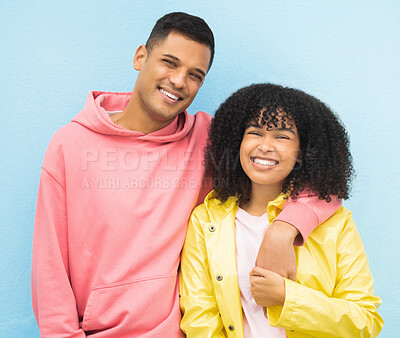 Buy stock photo Happy couple, smile portrait and cool fashion standing in blue background for love, support and care. Black woman, man and happiness hug together for trendy gen z or millenial street style clothes