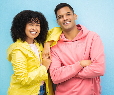 Buy stock photo Couple of friends, portrait and happy people on isolated blue background in fashion, afro hair trend and cool style clothes. Smile, man and black woman bonding with arms crossed or weather raincoat