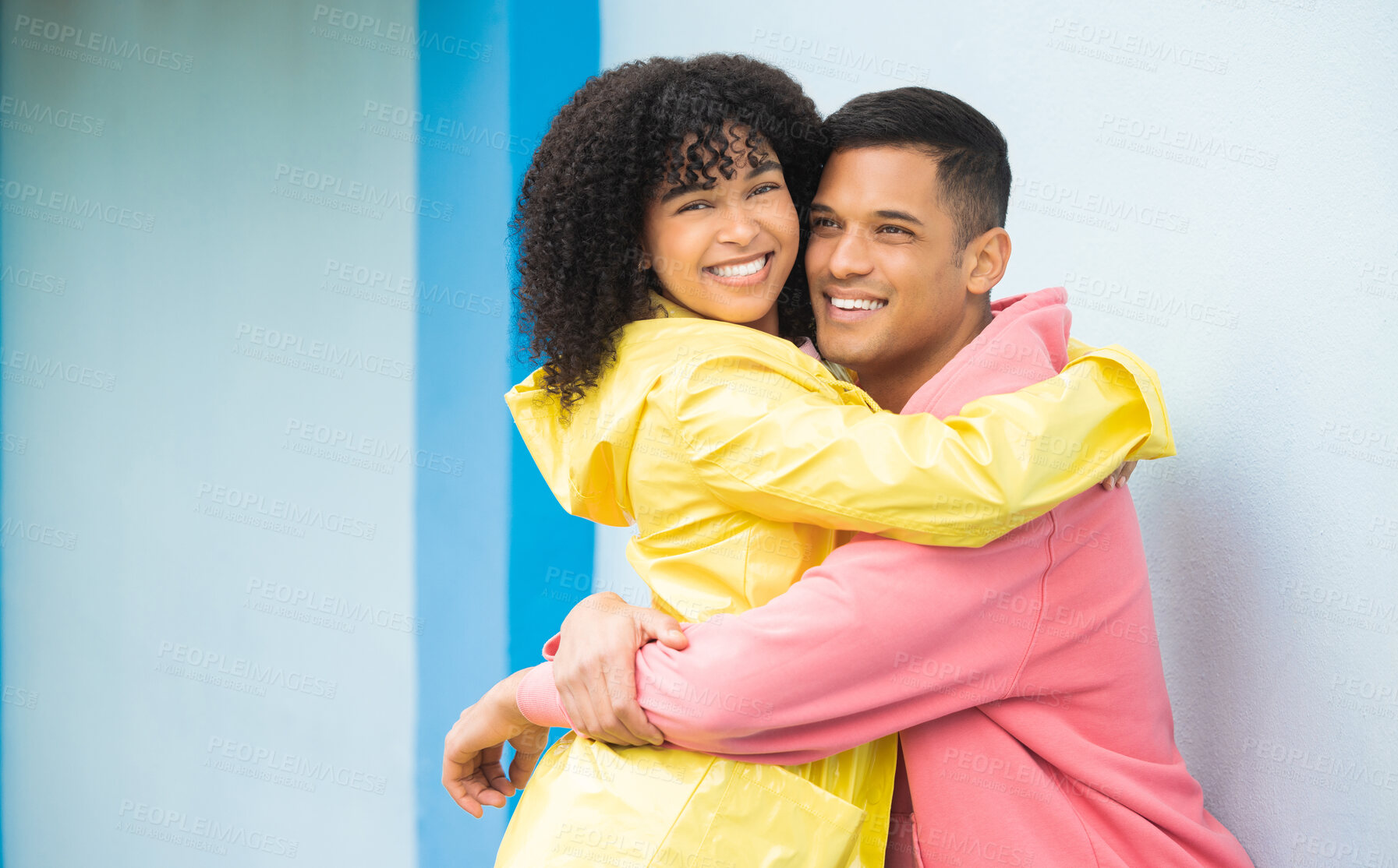 Buy stock photo Couple, smile and hug in portrait, happy mockup with love and commitment, partner isolated on blue background. Interracial relationship, commitment and together in studio with happy people and trust