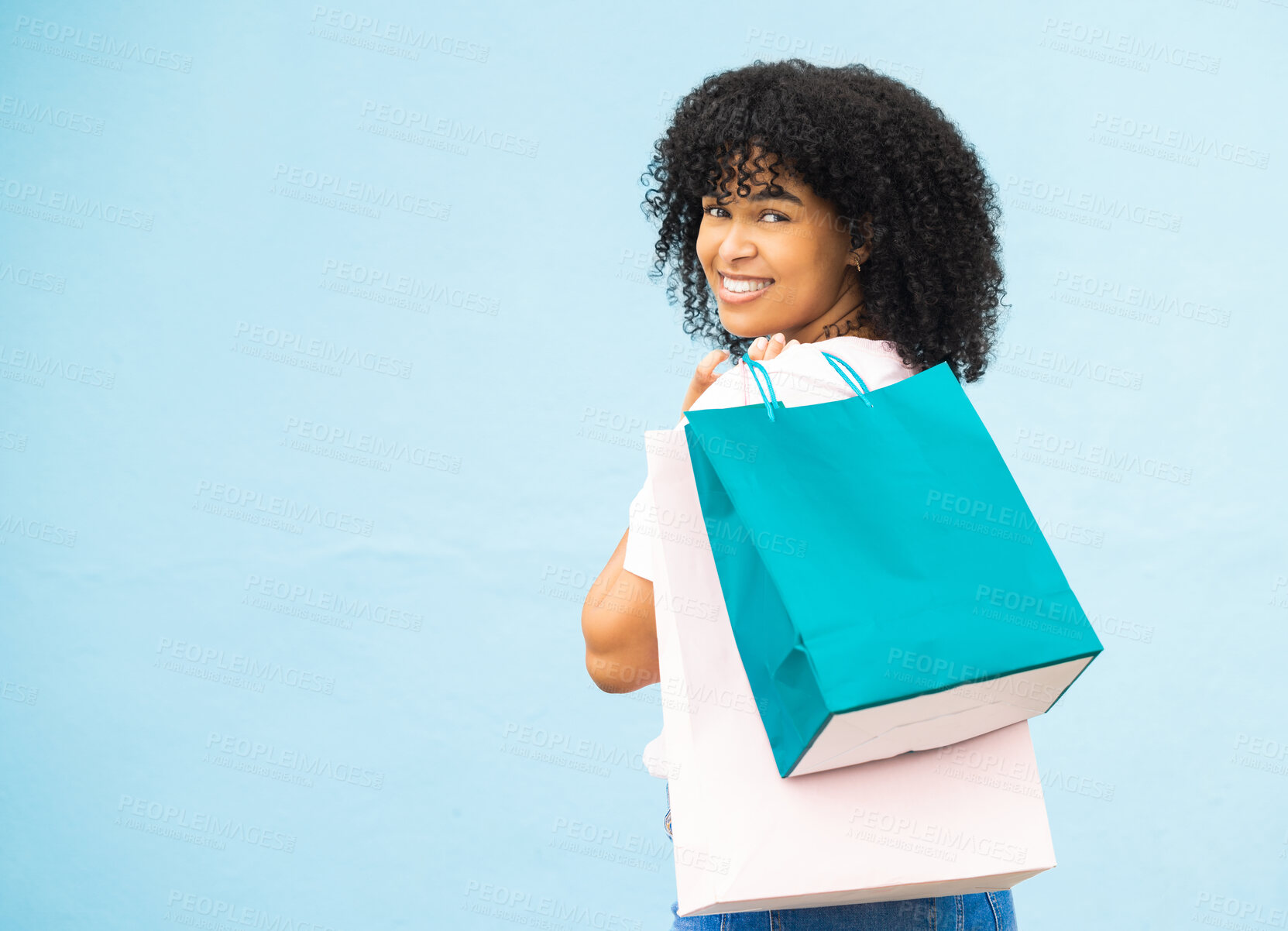 Buy stock photo Back, portrait and black woman with bags, shopping and purchase expensive items with girl on blue studio background. Mockup, Jamaican female and customer with boutique clothes, retail and discount