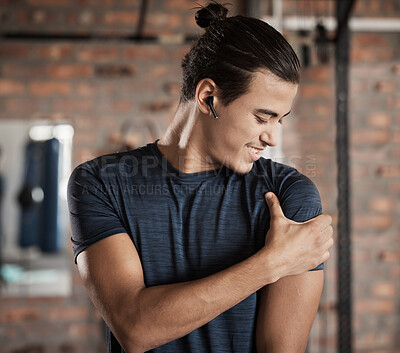 Buy stock photo Arm, shoulder muscle hold and man in a exercise, fitness and wellness gym happy about target goal. Sports, athlete and healthy young person with a smile after training and workout in a health club