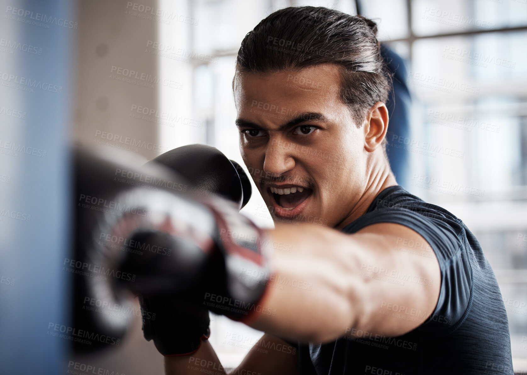 Buy stock photo Boxer, sports and man with punching bag training for fitness, fight gym exercise or intense power challenge. Strong athlete, angry fighter or person boxing for health performance, cardio or workout