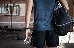 Exercise, bag and back of man in gym ready to start workout. Sports, fitness and hands of male athlete with water bottle for hydration and preparing for training and exercising for health or wellness