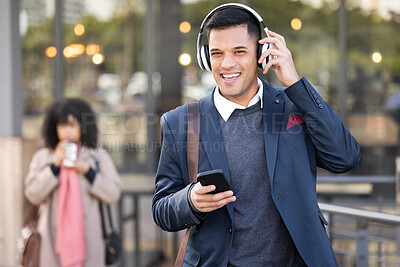 Buy stock photo Phone, headphones and businessman walking in the city while listening to music, radio or podcast. Happy, smile and portrait of a professional corporate male commuting to work in the town street.