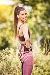 Woman runner, portrait and smile in nature park for fitness, health or music for motivation, plants and happy. Outdoor training, running and relax in woods for muscle development, exercise or freedom