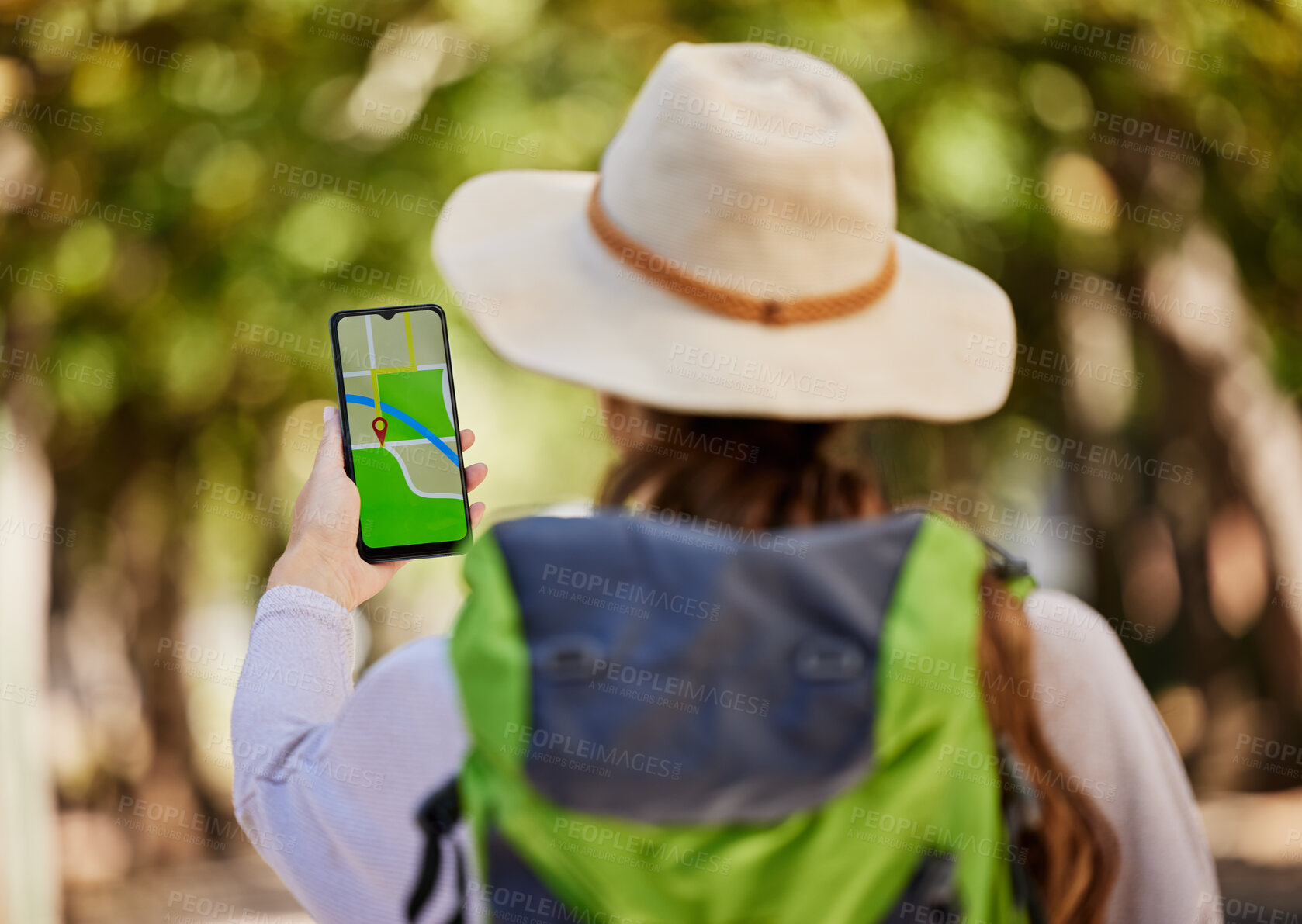 Buy stock photo GPS, direction and woman hiking in a forest for exercise, adventure or wellness in nature. Navigation app, phone and female hiker trekking on an outdoor trail in the woods alone with a mobile map.