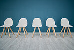 Chairs, line and waiting room in the office corridor for an interview, meeting or recruitment. Seats, row and empty stools in the hallway or boardroom of the modern business workplace for hiring.