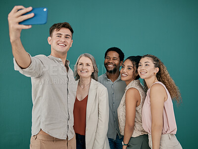 Buy stock photo Phone, selfie and group of business people in studio isolated on blue background. Teamwork, cellphone and friends, men and women taking pictures on mobile smartphone for happy memory or social media