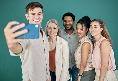 Buy stock photo Phone, selfie and group of business people in studio isolated on a blue background. Office, mobile technology and friends, men and women taking pictures on smartphone for happy memory or social media