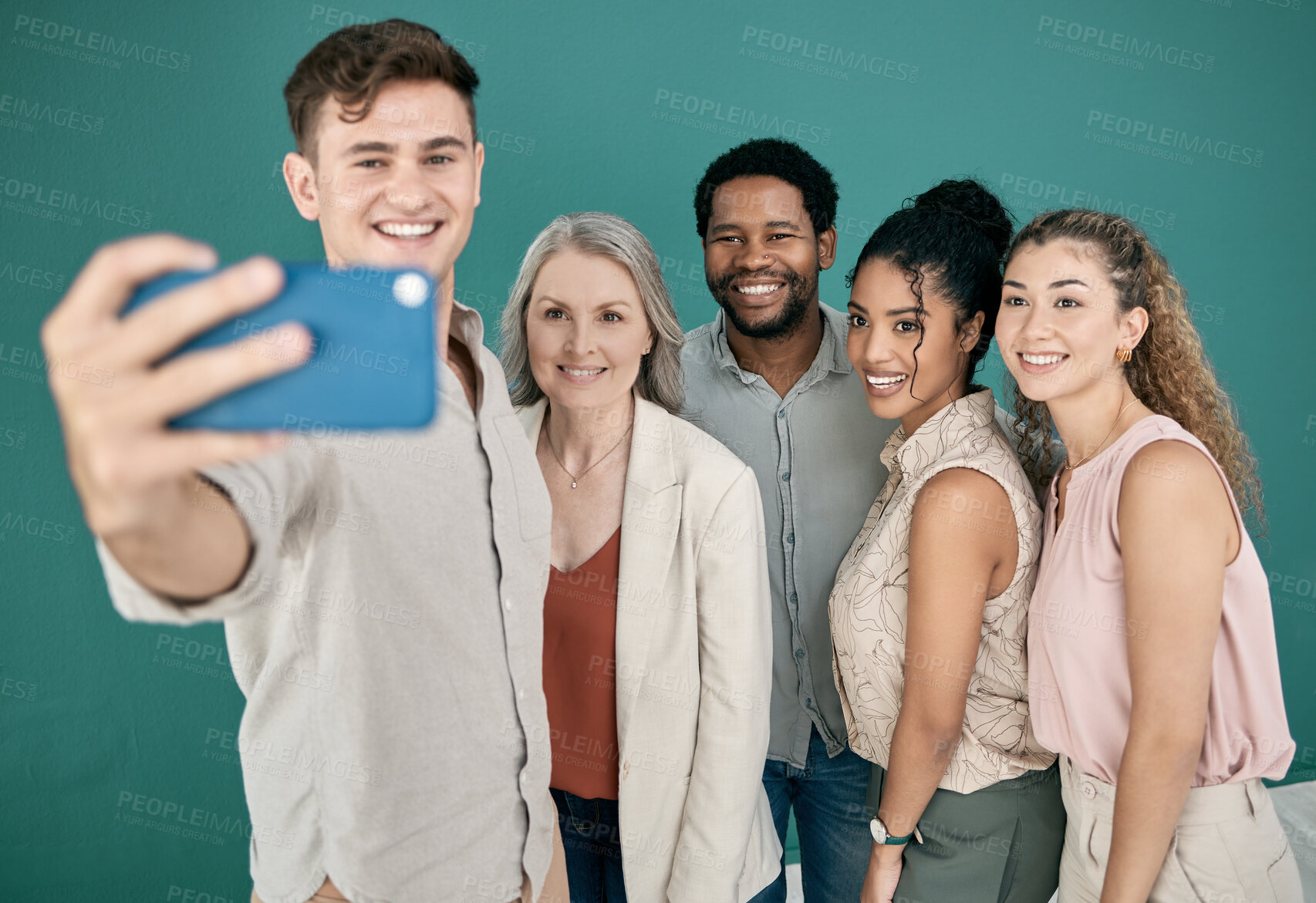 Buy stock photo Phone, selfie and group of business people in studio isolated on a blue background. Office, mobile technology and friends, men and women taking pictures on smartphone for happy memory or social media