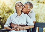 Happy old couple, hug and kiss in park with love, marriage and partnership with retirement together outdoor in nature. Elderly, life partner with care, trust and support, man and woman with happiness