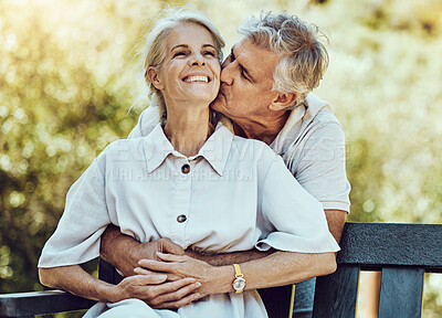 Buy stock photo Happy old couple, hug and kiss in park with love, marriage and partnership with retirement together outdoor in nature. Elderly, life partner with care, trust and support, man and woman with happiness