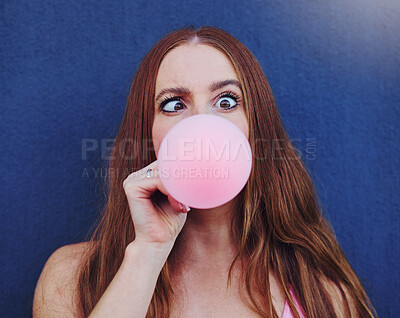 Buy stock photo Comic, bubblegum and portrait of girl on blue background with silly, funny and crazy facial expression in city. Freedom, fashion and face of woman with candy bubble for trendy, cool and urban style
