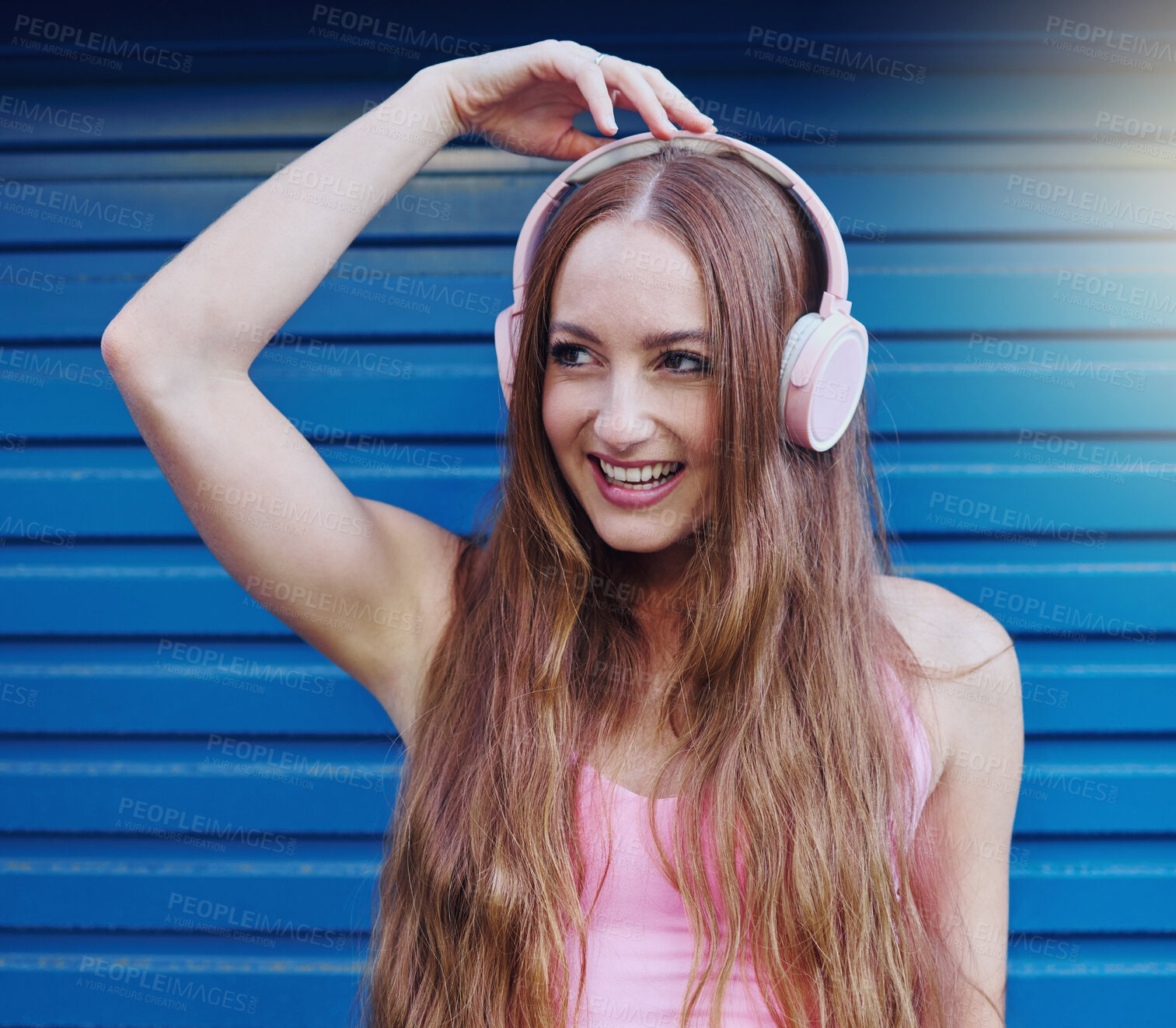 Buy stock photo Music, headphones and blue background with a woman listening to or streaming audio for fun. Radio, internet and 5g with an attractive young female using wireless technology to listen to a song