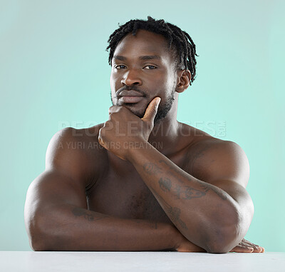 Buy stock photo Confident, handsome and portrait of a young black man isolated on a blue background in studio. Sexy, skincare and healthy body of an African model with muscle, confidence and seduction on a backdrop
