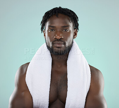 Buy stock photo Black man, skincare and portrait of face with towel for beauty, hygiene and grooming in studio. Healthy person on blue background for facial glow, clean skin and self care with dermatology cosmetic 