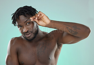 Buy stock photo Black man, eyebrow and tweezer in studio for portrait, beauty grooming or cosmetics by blue background. Model, cosmetic and facial hair removal with metal tools for aesthetic, skincare or self care