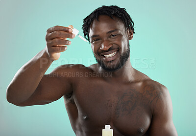 Buy stock photo Black man, studio and portrait with skincare serum, cosmetic beauty or grooming by blue background. Model, cosmetic and facial product for skin glow smile for aesthetic, cleaning or self care process