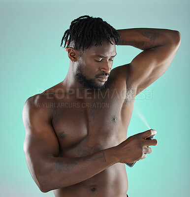 Buy stock photo Body hygiene and black man with deodorant spray product for self care routine of people in studio. Health, wellness and cosmetic grooming of person with skincare at isolated green background.



