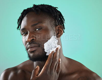 Buy stock photo Black man, apply foam and studio portrait for shaving, skincare or safety for cosmetics by blue background. African gen z model, hair removal cream of face beauty for aesthetic, cleaning or self care