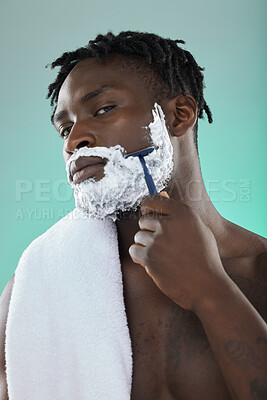 Buy stock photo Black man, studio and cream for shaving, beauty or razor for facial, cosmetics or skincare by blue background. African gen z model, hair removal foam and shave for aesthetic, cleaning and self care