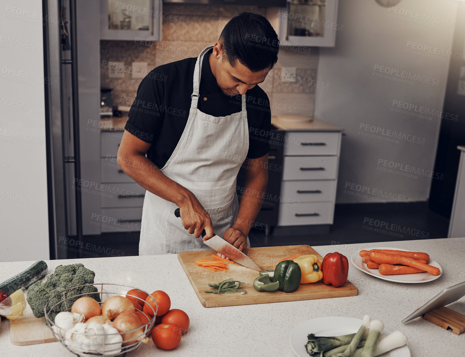 Buy stock photo Cooking, food and vegetables with a man cutting ingredients in the kitchen on a wooden chopping board. Salad, health and diet with a male chef preparing a meal while standing alone in his home