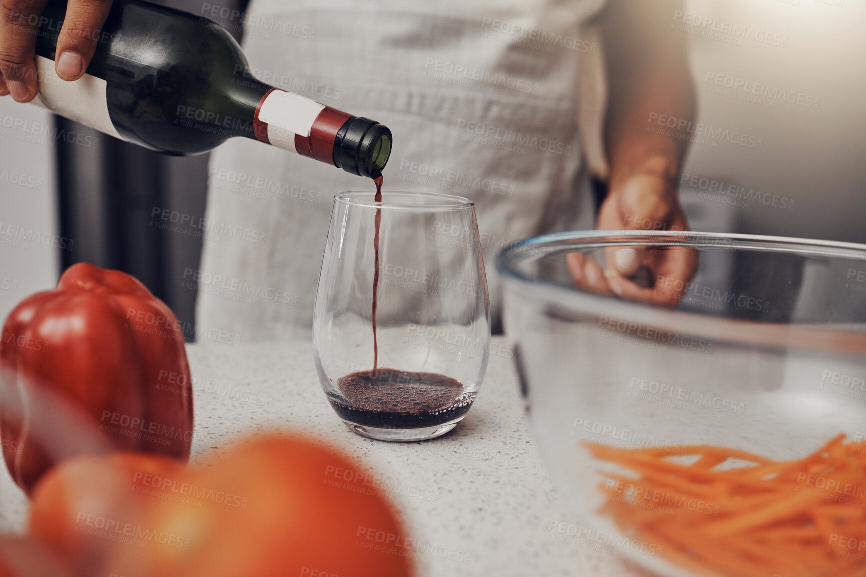 Buy stock photo Man, cooking vegetables and red wine glass, bottle and hands in kitchen while making salad. Chef person with alcohol for making dinner for healthy vegan eating lifestyle in a house or apartment 