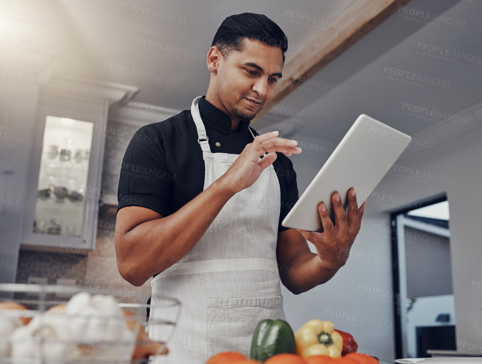 Buy stock photo Man, cooking vegetables and tablet in kitchen while online with house wifi connection for learning or blog. Chef person with mobile app for online recipe for home food for vegan or healthy eating