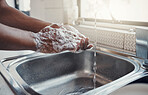 Cleaning, washing hands and kitchen sink with soap for health, home wellness and safety. Cleaner, bacteria prevention and man getting ready for cooking in a household with water doing house chores