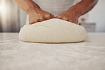 Man hands and cook kneading dough for baking preparation work and process at culinary counter. Restaurant chef and worker in professional kitchen preparing wheat bread or pizza recipe. 

