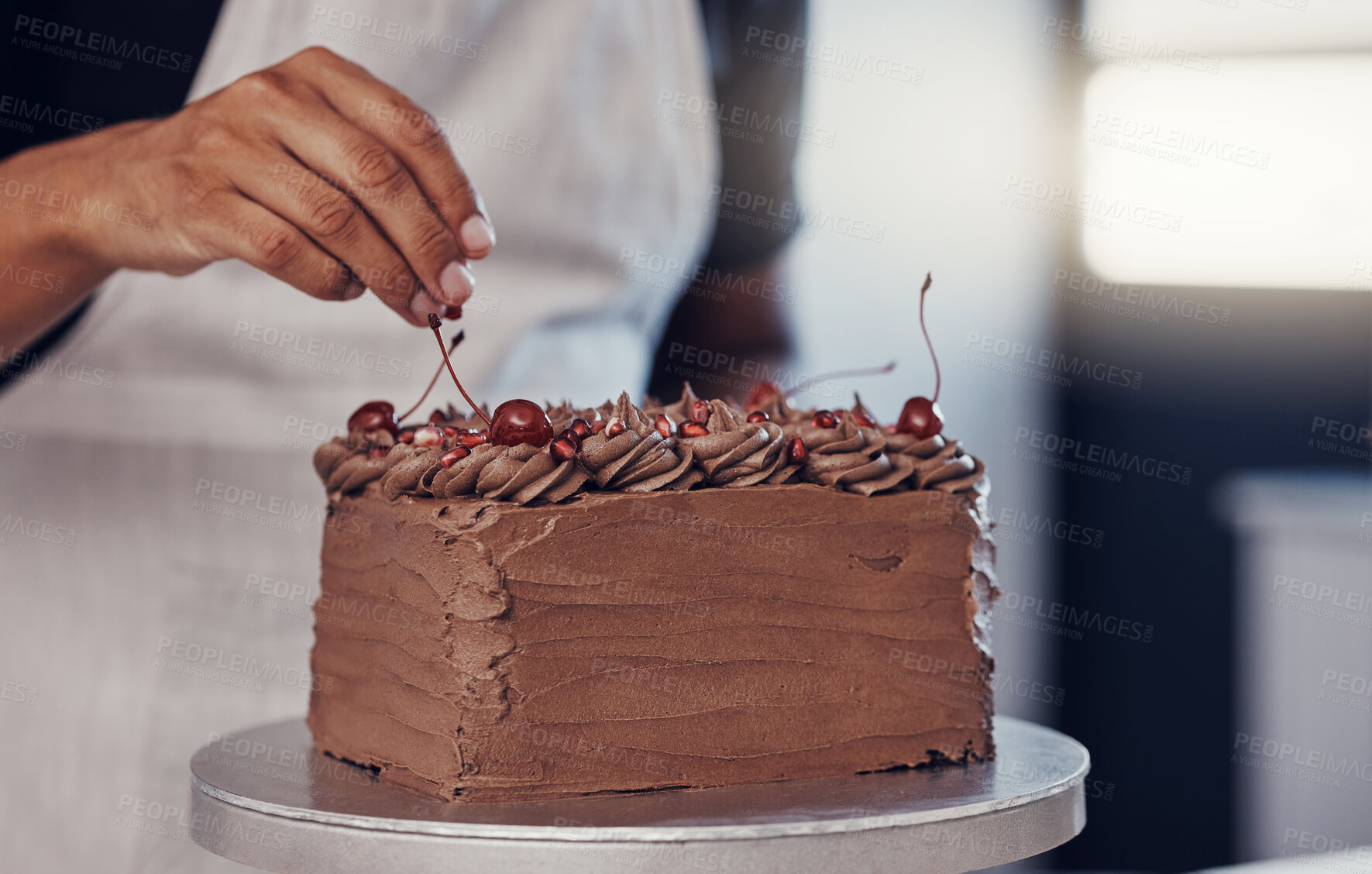 Buy stock photo Hand, cake and food with a man chef working in a kitchen while preparing dessert for a party celebration. Cooking, chocolate and cherries with a male at work in a bakery to make gourmet confectionary