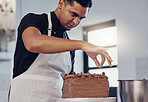 Kitchen, baking and man decorating cake with chocolate sprinkles and frosting with focus and skill. Sweets, small business and baker decorating dessert for birthday event and pastry chef in bakery.