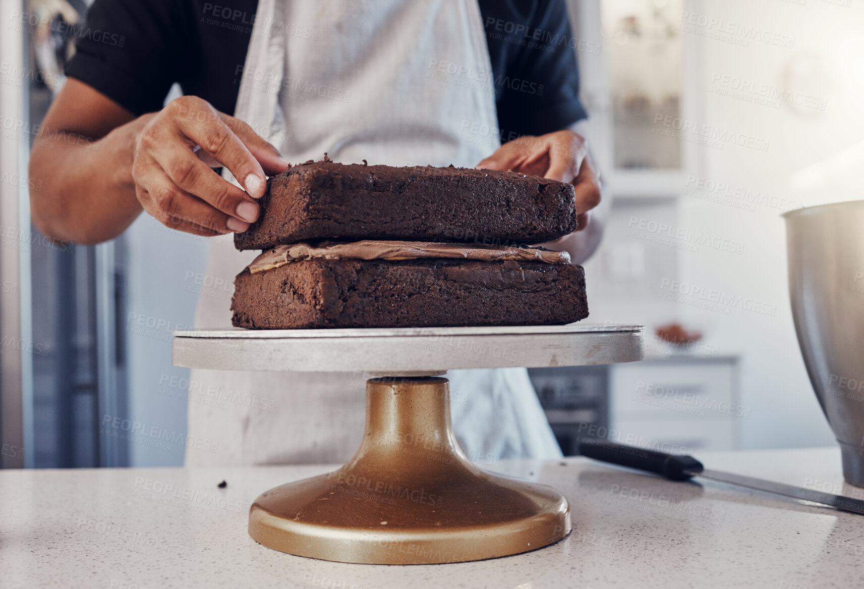 Buy stock photo Layering, preparation and hands of a man with a cake for a birthday, dessert and sweet treat. Kitchen, working and chef in a bakery baking food, confectionery and unhealhy snack on a counter