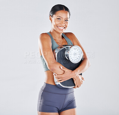 Buy stock photo Diet, portrait and scale with a black woman athlete in studio on a gray background for body positivity or health. Fitness, weightloss and losing weight with a young female posing for wellness