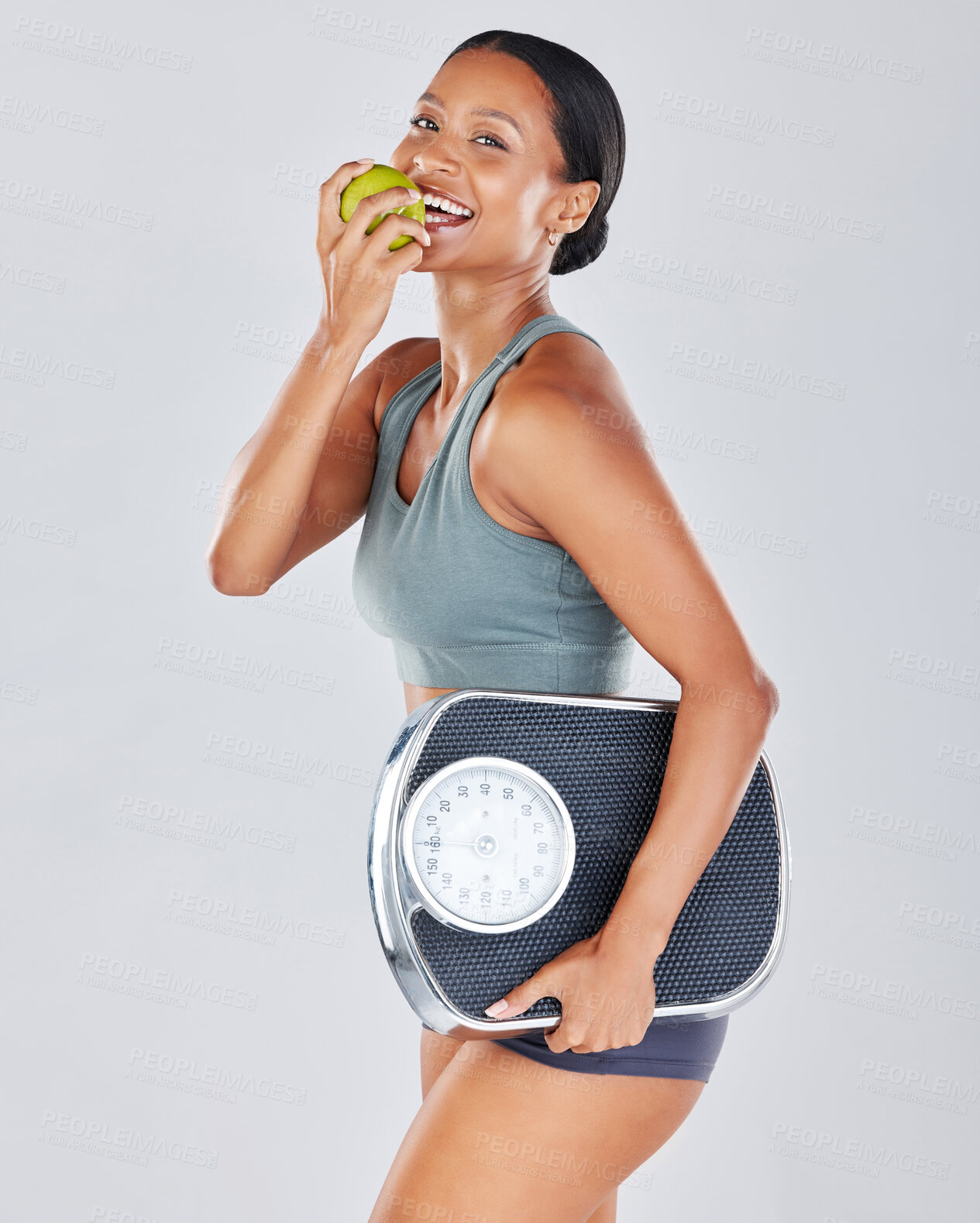 Buy stock photo Portrait, scale and black woman eating apple on diet for weightloss, workout and health lifestyle. Fitness, nutrition and body wellness, healthy girl isolated on white background in studio with fruit