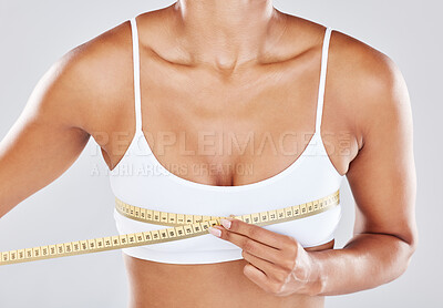 Breast, measure tape and woman isolated on white background for cosmetics, plastic surgery and lose weight. Liposuction, health and wellness of person or model with boobs for beauty results zoom