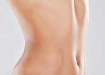 Woman, stomach and slimming wellness or skincare for plastic surgery, liposuction or digestion nutrition in white background. Model, belly and tummy tuck or cosmetics dermatology healthcare in studio